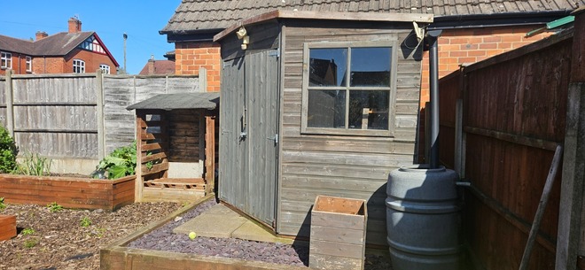 Good size south facing plot with shed and planters 